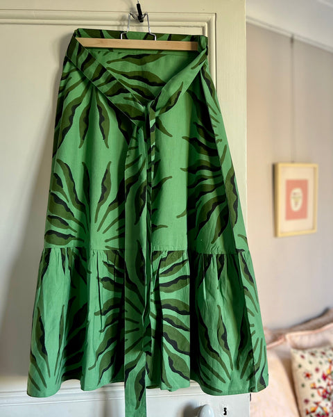 Beautiful green and black block-printed wrap skirt with ruffle on hanger