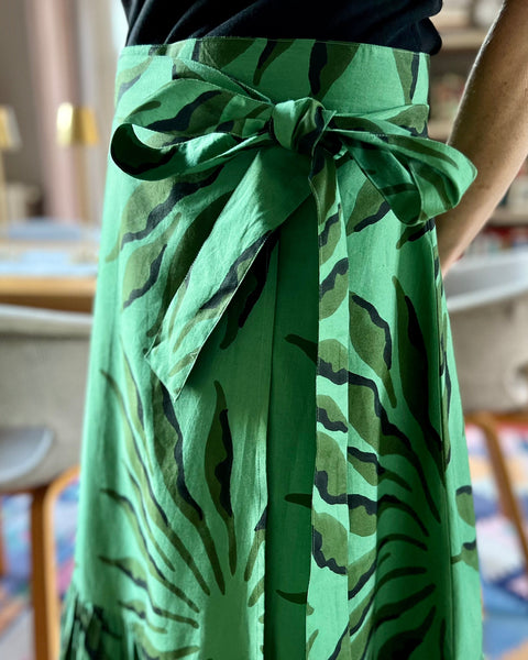 Beautiful green and black block-printed wrap skirt with bow on woman 