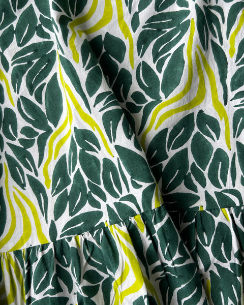 Close-up of chartreuse snake ruffle wrap skirt with a dark teal green and chartreuse print