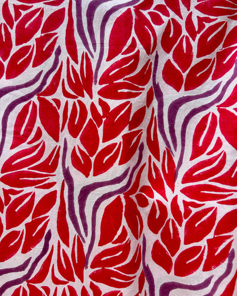 Block printed fabric with red and purple leaf pattern