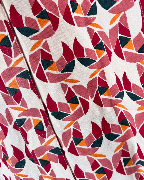 Close-up of a tote bag with a colorful block-printed pattern featuring mollusks.