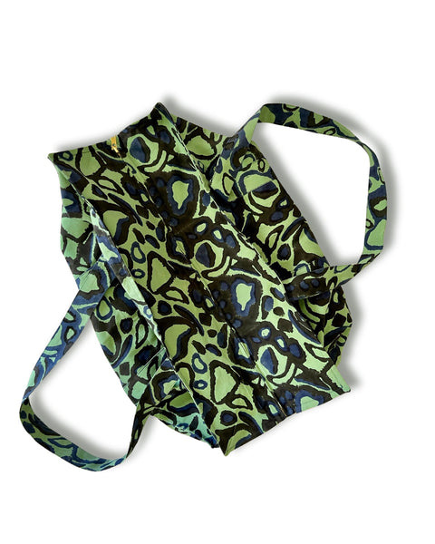 A green and black block printed tote bag with an animal print pattern.