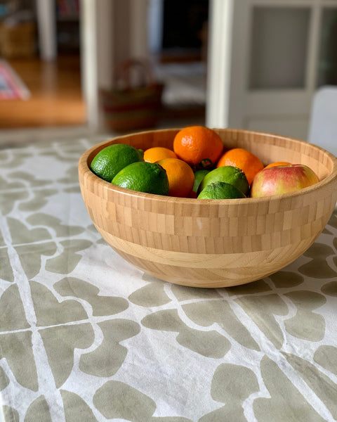 Wooden bowl with fruit on a hand block-printed sand / khaki and cream table runner