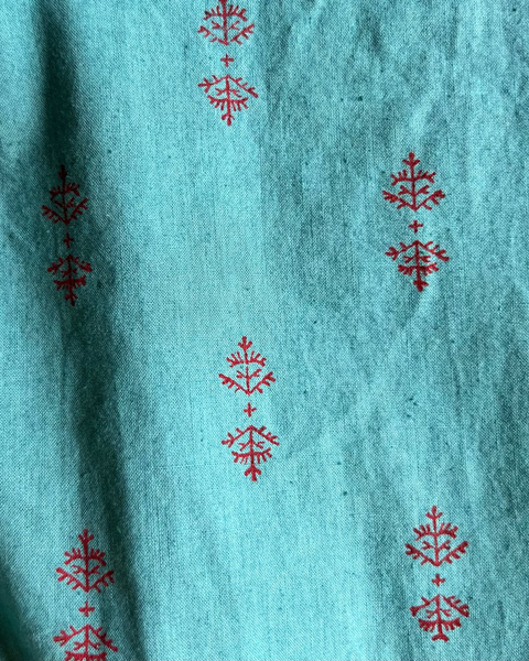 Close-up of teal and red block-printed fabric