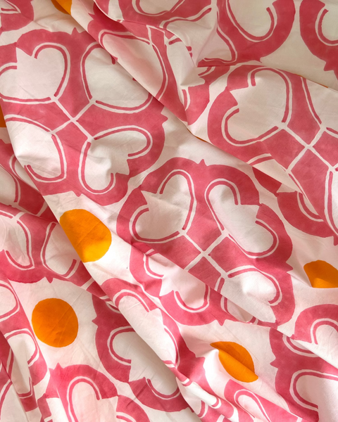 Close-up of a watermelon pink and orange condor wrap skirt 