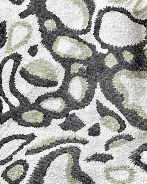 Close-up of gray, khaki, and white hand block-printed napkin