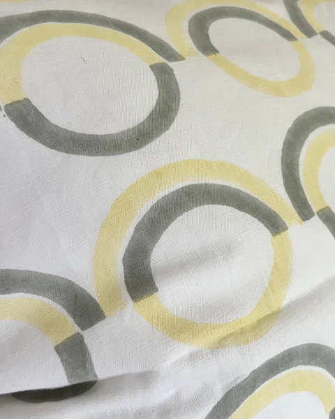 Close-up of organic cotton linen hand block-printed pillow sham with gray and butter yellow pattern