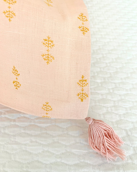 Close-up of organic cotton linen hand block-printed blush pink pillow sham tassel