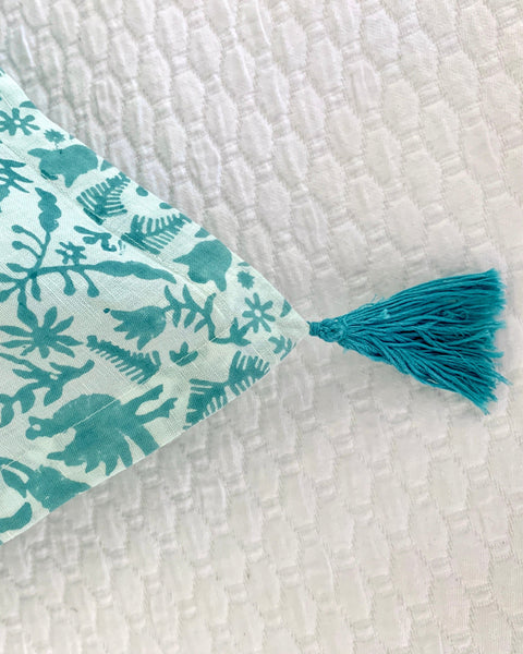 Close-up of qqua / sage blue and ice blue hand block-printed organic cotton linen jaguar print pillow sham tassel