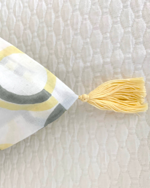 Close-up of organic cotton linen hand block-printed pillow sham yellow tassel