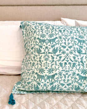 Aqua / sage blue and ice blue hand block-printed organic cotton linen jaguar print pillow sham with tassels on luxurious bed