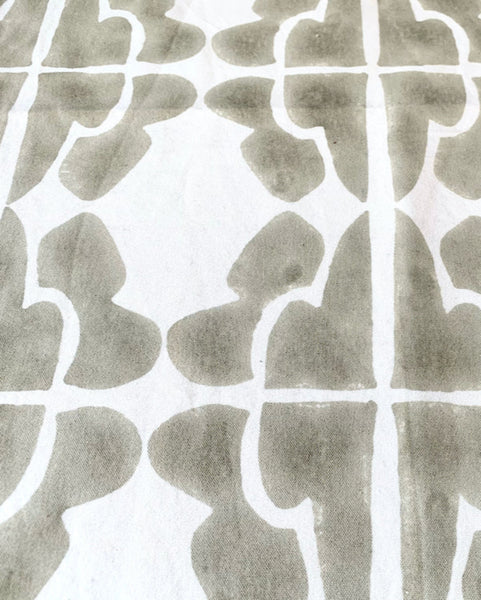Close-up of a hand block-printed sand / khaki and cream table runner
