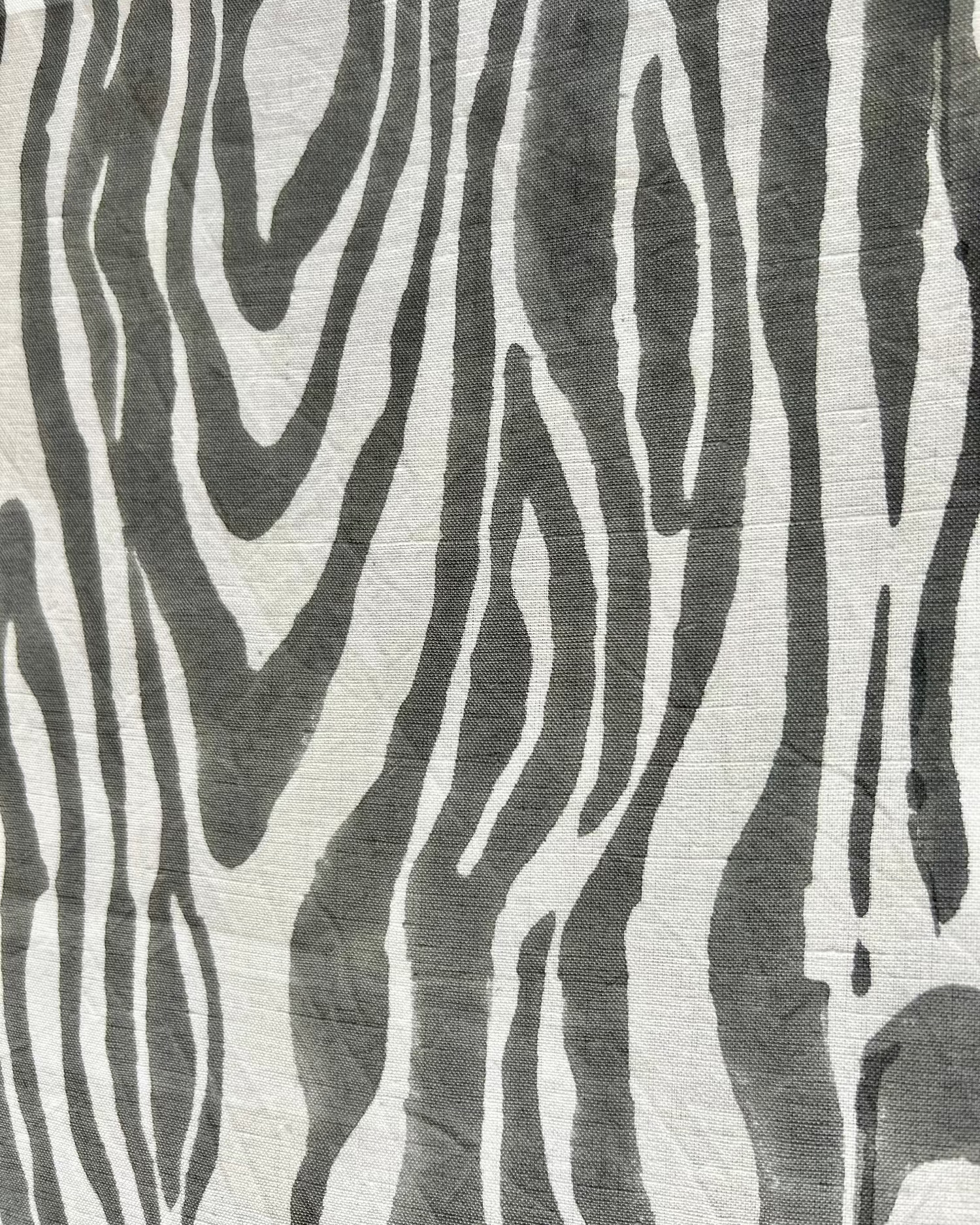 Close-up of a gray and white faux bois hand block-printed organic cotton linen table runner 